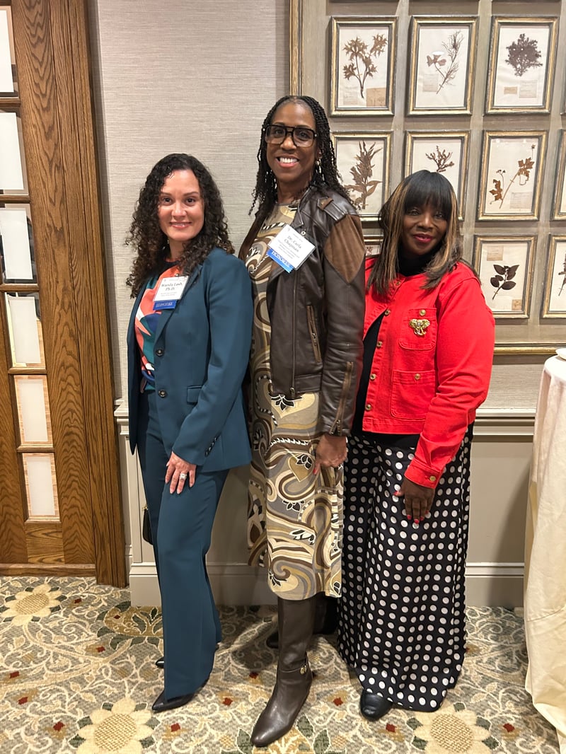 Mary Outley, Wanda Lash, and Carla Chapman pose for a photo after being honored for their new positions.